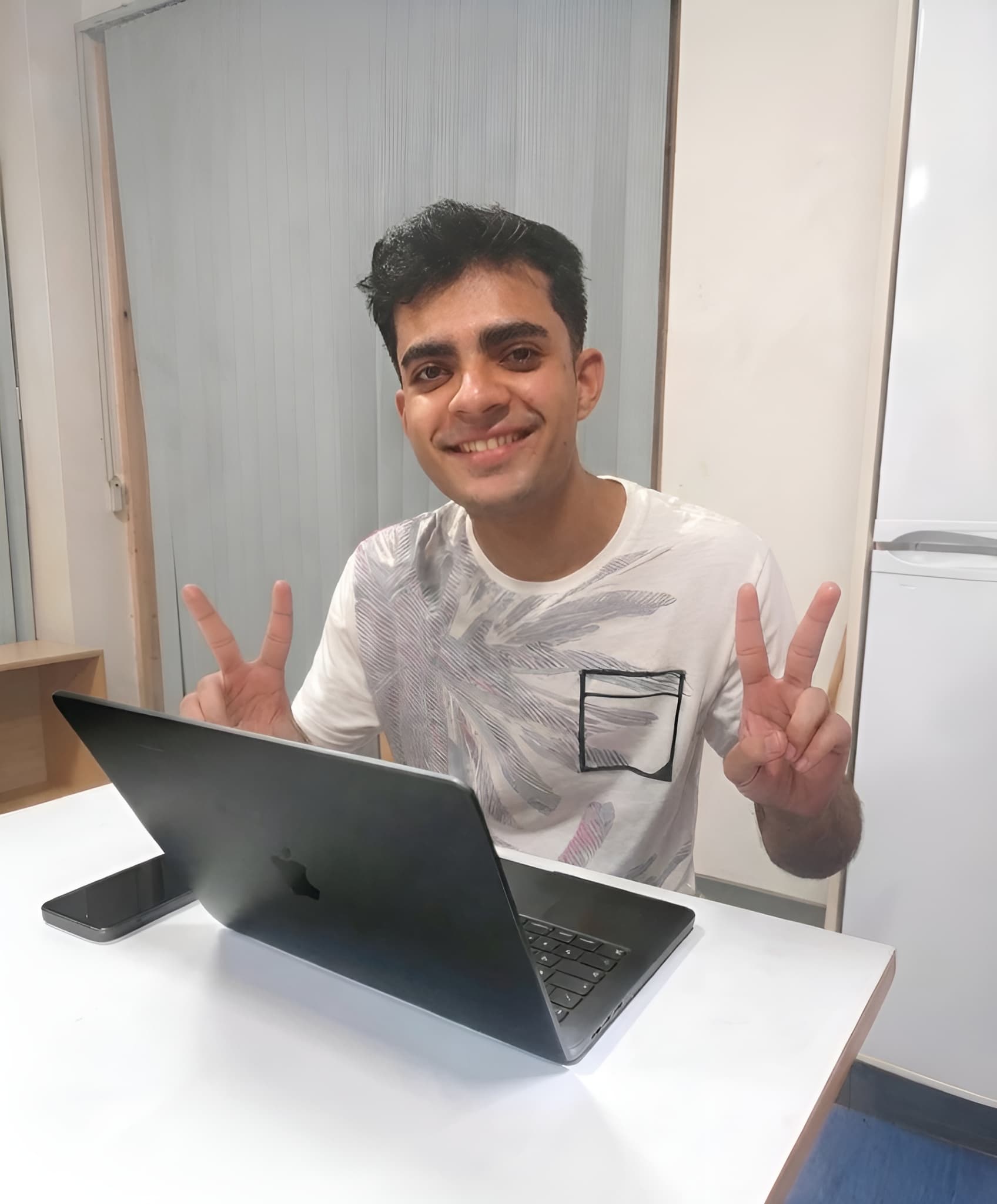 Harshit sitting behind a laptop
